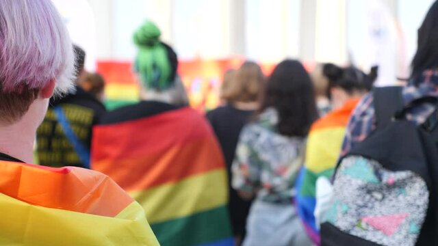 LGBTQ people listen to speakers at pride event