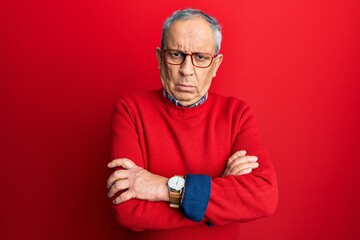 Handsome senior man with grey hair wearing casual clothes and glasses skeptic and nervous,...