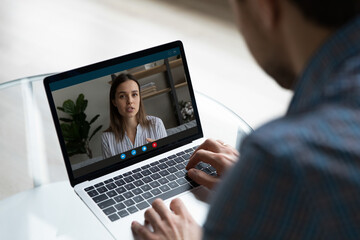 Fototapeta na wymiar Employer and candidate having remote job interview on virtual conference chat. Coworkers meeting online, making work video call on laptop Man watching learning webinar, training from teacher, coach