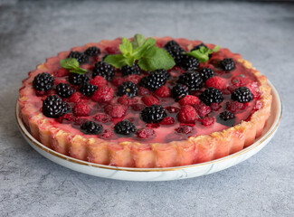 Tyrolean pie with fresh raspberries and blackberries close-up
