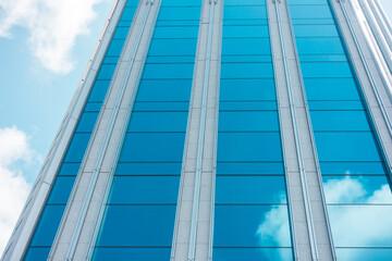 Obraz premium underside panoramic and perspective view to steel blue glass high rise building skyscrapers, business concept of successful industrial architecture