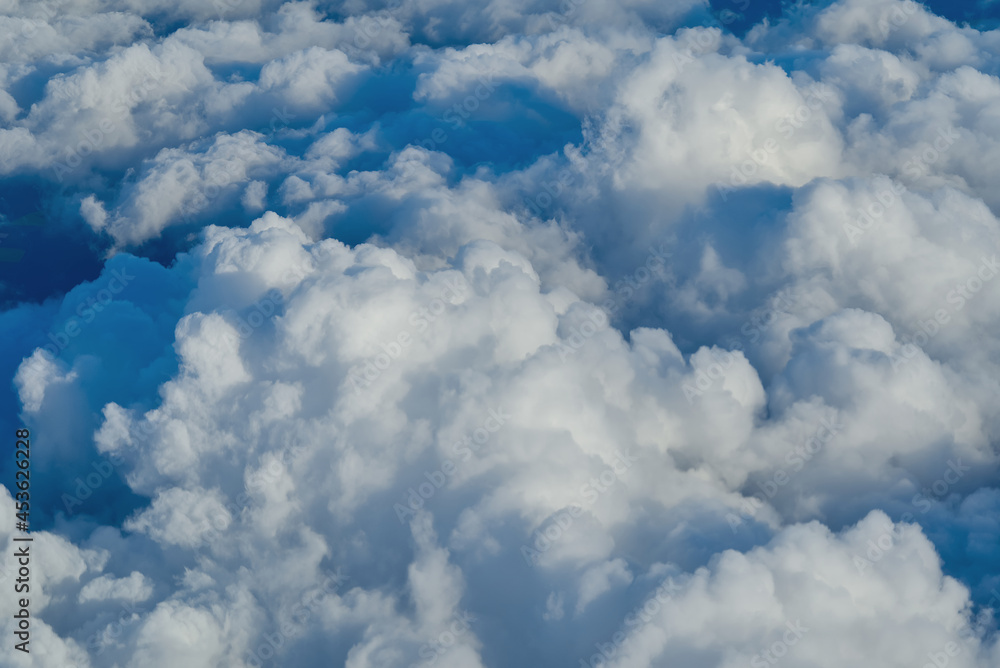 Poster view of the sky above the clouds. blue sky high view from airplane window clouds shapes. sky-clouds 