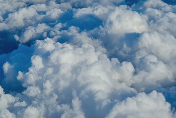 View of the sky above the clouds. blue sky high view from airplane window clouds shapes. sky-clouds background. Above the cloud