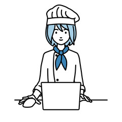 デスクで座ってPCを使っている調理師の女性
