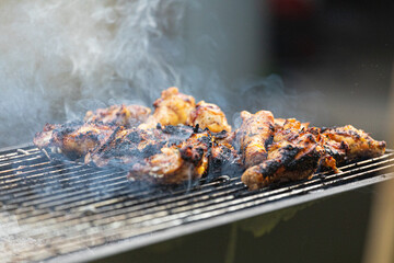 Chicken meat being cooked on a grill