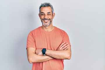 Handsome middle age man with grey hair wearing casual t shirt happy face smiling with crossed arms...