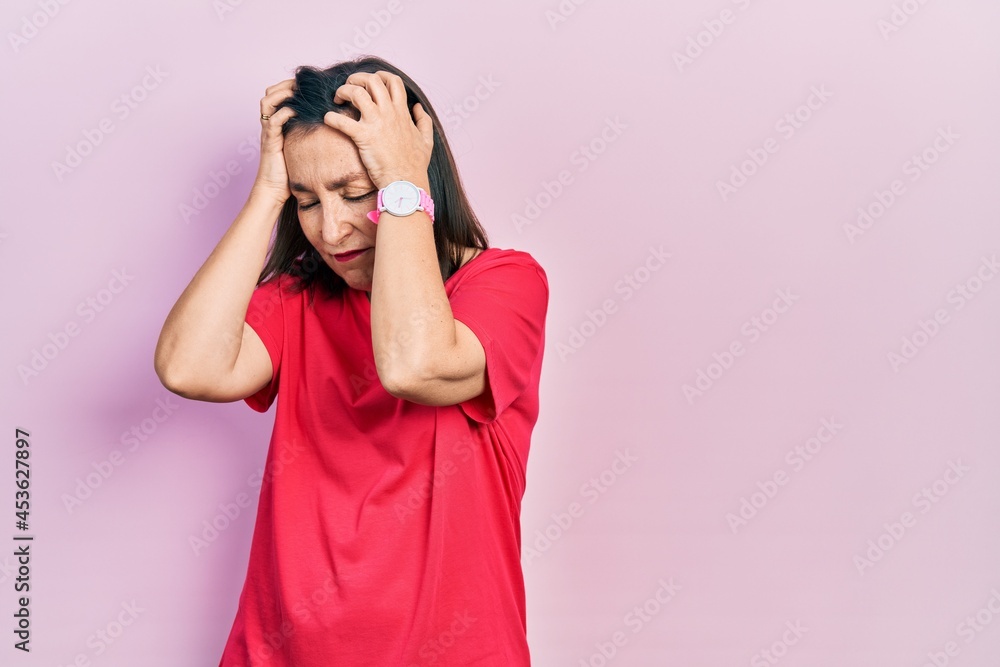 Poster Middle age hispanic woman wearing casual clothes suffering from headache desperate and stressed because pain and migraine. hands on head.