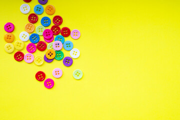 Cloth buttons on the yellow background with copyspace
