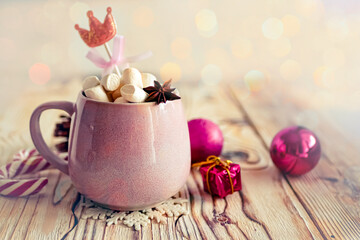Obraz na płótnie Canvas Christmas drink background, pink cup with hot chocolate and marshmallows on a wooden table near New Year's decor. Cocoa Christmas drink, copy space, bokeh effect, drink mug Christmas holiday 