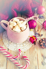 Christmas drink background, pink cup with hot chocolate and marshmallows on a wooden table near New Year's decor. Cocoa Christmas drink, copy space, bokeh effect, drink mug Christmas holiday 