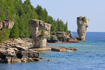 The two rock pillars rise from the waters of Georgian Bay on Flowerpot island in Fathom Five National Marine Park, Lake Huron, Canada
