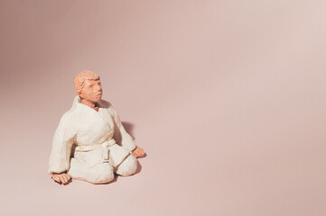 martial arts student on a pastel pink background.