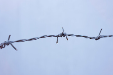 Old barbwire hanging in the air,rust and dirty