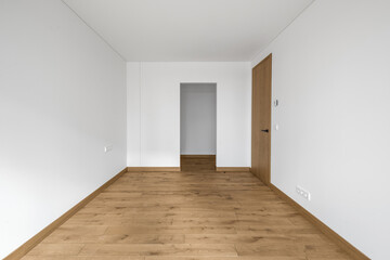 Empty minimalist modern room with white walls, closed  wood door and oak wood floor