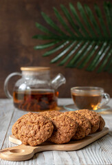 Homemade oatmeal cookies with glass teapot of green tea.