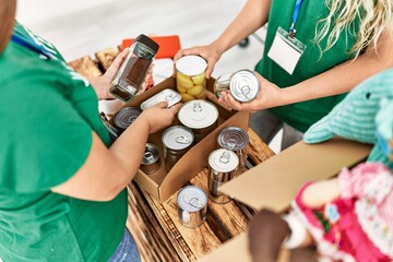 Two young volunteers woman working at charity center.