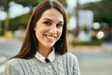 Young hispanic woman smiling happy standing at the city.