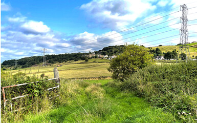 Fototapeta na wymiar Rural scene near, Lee Lane, with fields, houses, and blue skies near, Bingley, Bradford, UK