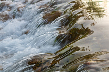 Close up of water flow over a small waterfall