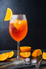 Aperol spritz cocktail and bar accessories. Italian aperol spritz cocktail and a sliced orange on a...