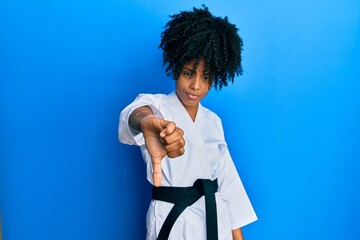 African american woman with afro hair wearing karate kimono and black belt looking unhappy and angry showing rejection and negative with thumbs down gesture. bad expression. © Krakenimages.com