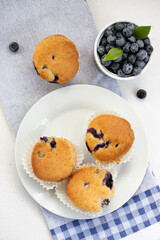 Vegan glutenfree vegan muffins with bluebarries on a white plate