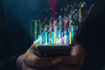 A man using smart phone analyzing graph for data management to make report.Financial technology,Laptop ,many graphs.Investment.Photo concept of Data analyst and financial.