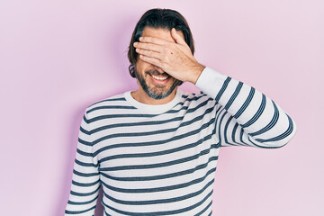 Middle age caucasian man wearing casual clothes smiling and laughing with hand on face covering eyes for surprise. blind concept.