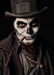 Young man in image of Baron Samedi, the Voodoo deity. Baron Saturday dressed in black coat and top...