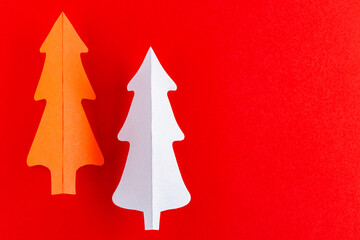 Naklejka na ściany i meble Red paper christmas tree. Paper Christmas tree on a red background. New Year decoration