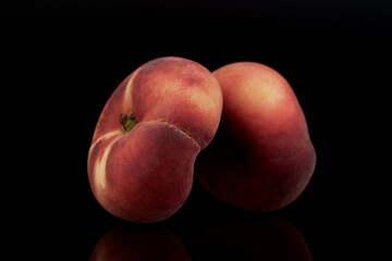 Fototapeta na wymiar Two organic ripe fig peaches, close-up, isolated on black.