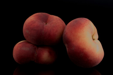 Fototapeta na wymiar Three organic ripe fig peaches, close-up, isolated on black.