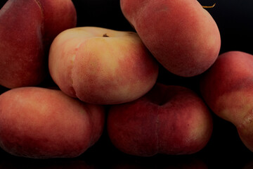 Fototapeta na wymiar Several organic ripe fig peaches, close-up, isolated on black.