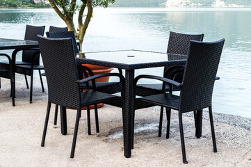 Table with chairs in cafe at seashore.