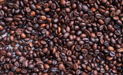 Brown and black coffee beans. Roasted arabic espresso coffee grains.