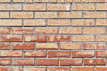 Brick wall texture with cracked tiles and cement. Classic brickwall surface background