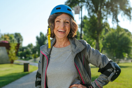 Happy Mature Woman Rollerblading In The Park