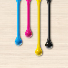 cmyk ink drops on beige wooden square background