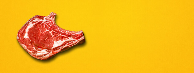 Beef prime rib isolated on yellow background. Horizontal banner