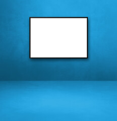 Black picture frame hanging on a blue wall
