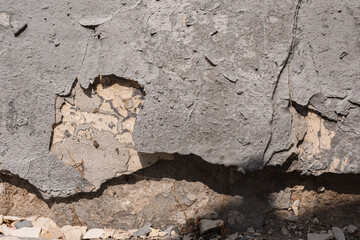 Old wall-  destroyed plaster. Grainy background- cracks, chips, peeling paint