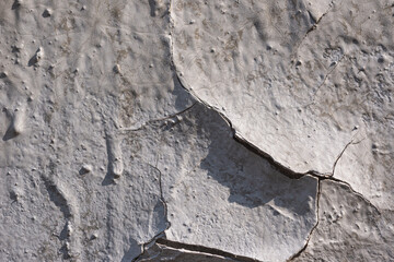 Old wall-  destroyed plaster. Grainy background- cracks, chips, peeling paint