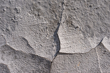 Old wall-  destroyed plaster. Grainy background- cracks, chips, peeling paint