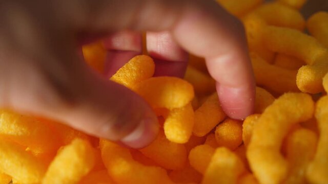 taking cheese crisps chips snacks from a bowl party snack