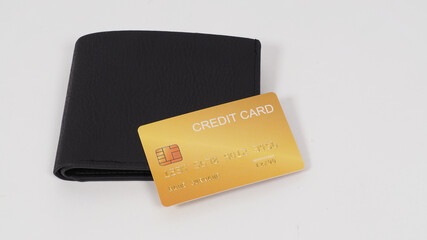 Credit card gold color in black on wallet on white background..