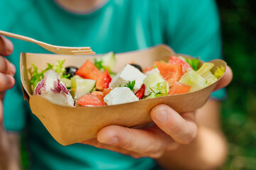 Vegetable salad in the brown kraft paper food container