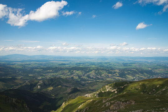 Top view on Zakopane from Tatra mountains trail with vivid cloudy sky © Dawid G