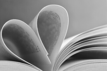 book pages connected in the shape of a heart black and white photography