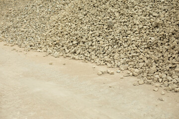 The building stone is poured on the construction site. Small stone for construction.