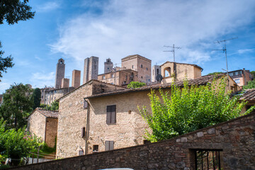 San Gimignano, Italy- July 18, 2021: View of the famous medieval city in Tuscany, famous for its ancient buildings and towers